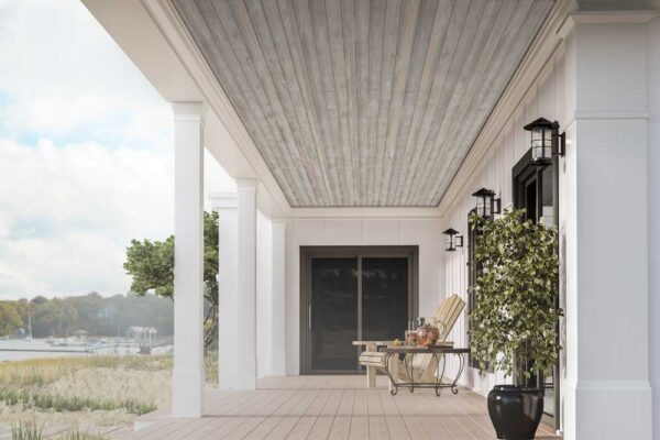 Covered porch with Easy Barnwood “Sterling Gray” plank ceiling, white columns and siding, black wall lanterns, and coastal water view.