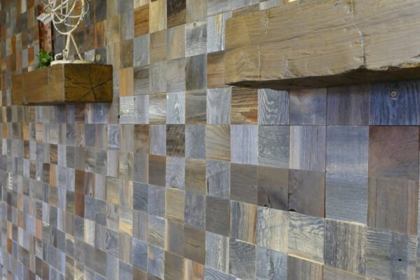 Wood square mosaic feature wall with floating shelves and a small bar cart.
